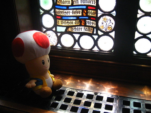 Toad reads some fairy tales etched in the stained glass
