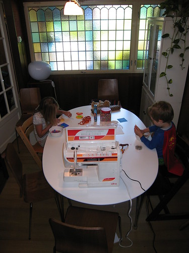 The kids doing crafts at the diningtable