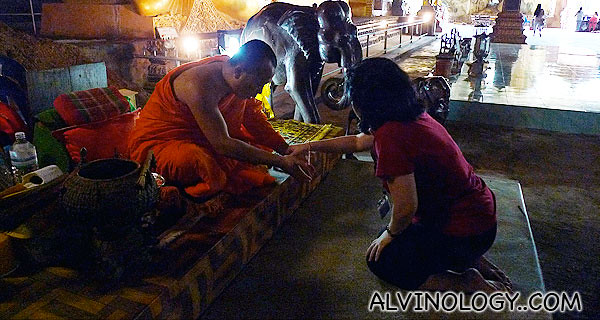 Nicole getting blessed by a Thai monk