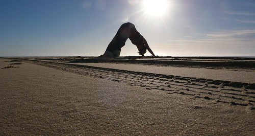 downward dog on the beach in the AM