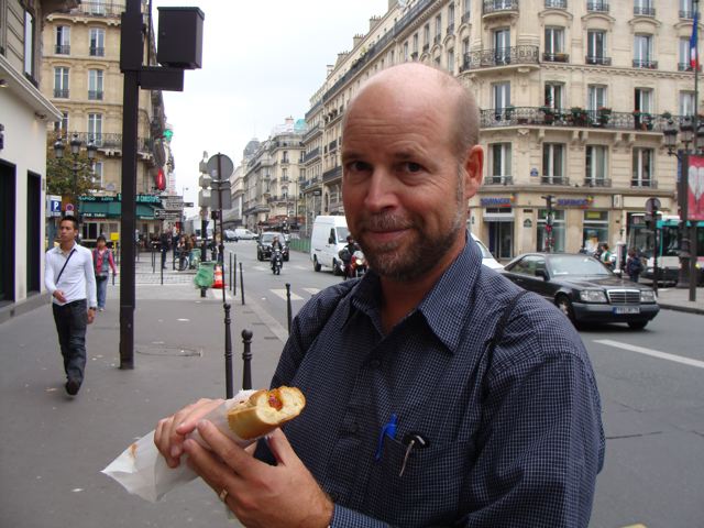 Runner Tim Penning enjoys a hot dog (in a baguette) in Paris.