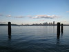A photo of the Seattle skyline in the distance over water.