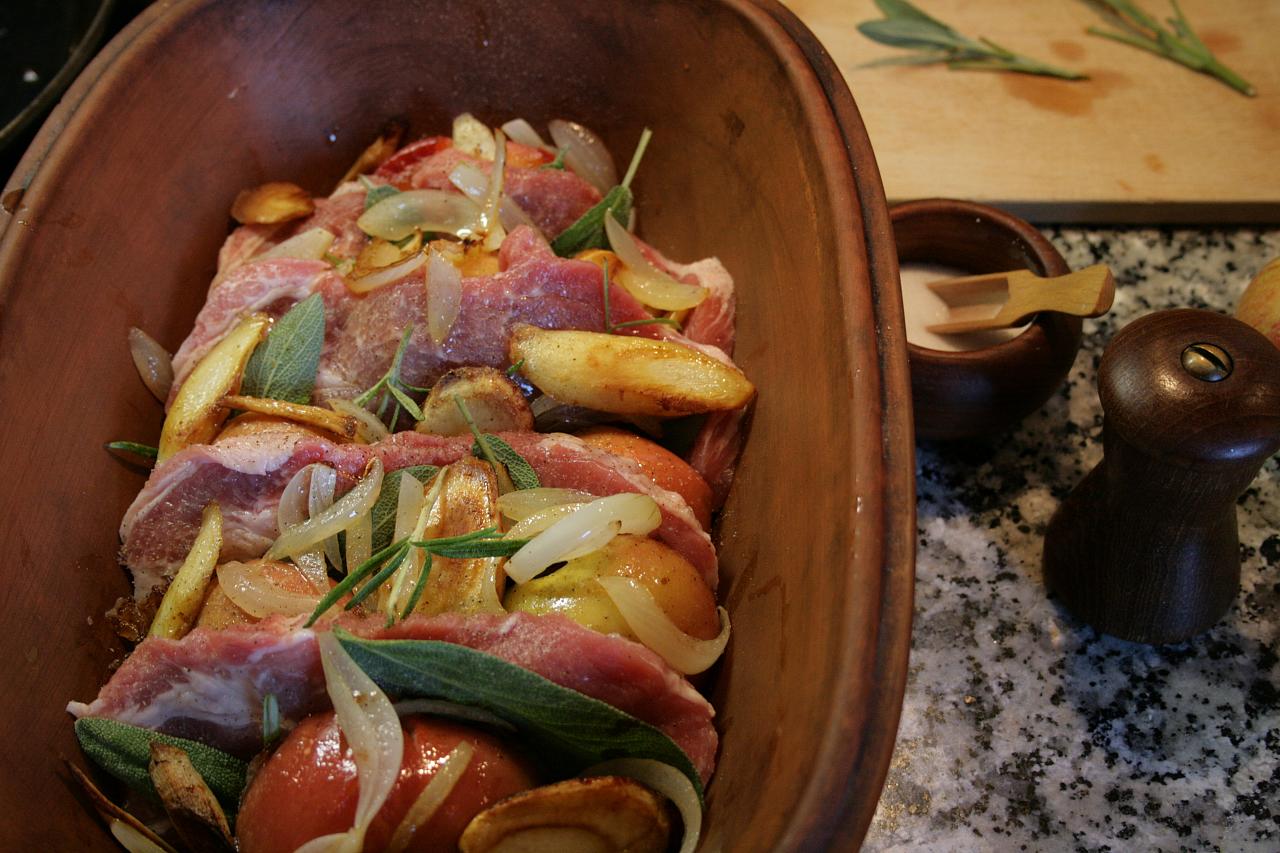 Baked pork chops with apples and parsley roots, flavoured with sage and rosemary