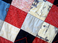 detail of red blue patchwork quilt