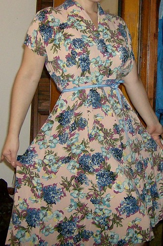 Soft, gorgeous flowing rayon.  This dress is a tad big, and needs some hem repair and a belt.