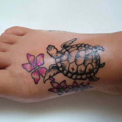foot tattoo flowers n turtle Photo by wild dark and stormy