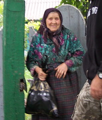 A woman receiving food and water with thanks
