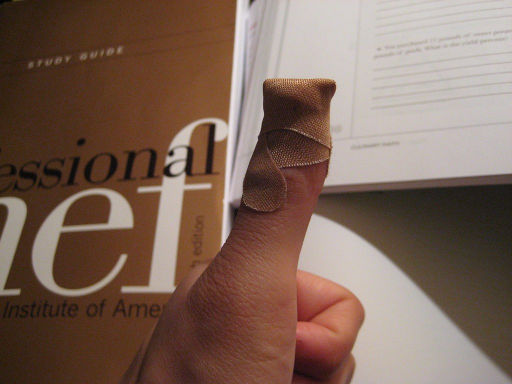 My bandaged thumb and a mountain of homework