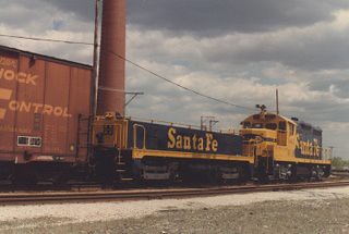 Atchinson, Topeka & Santa Fe Railroad rebuilt EMD GP -9 and slug unit switching the south hump at Corwith Yard. Chicago Illinois. April 1984.