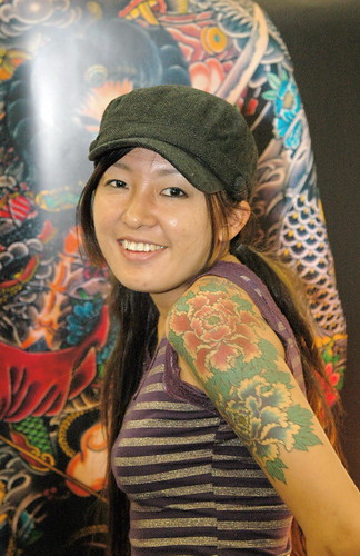 Asian girl with flower tattoo and koi