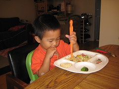 Eating pasta with chopsticks