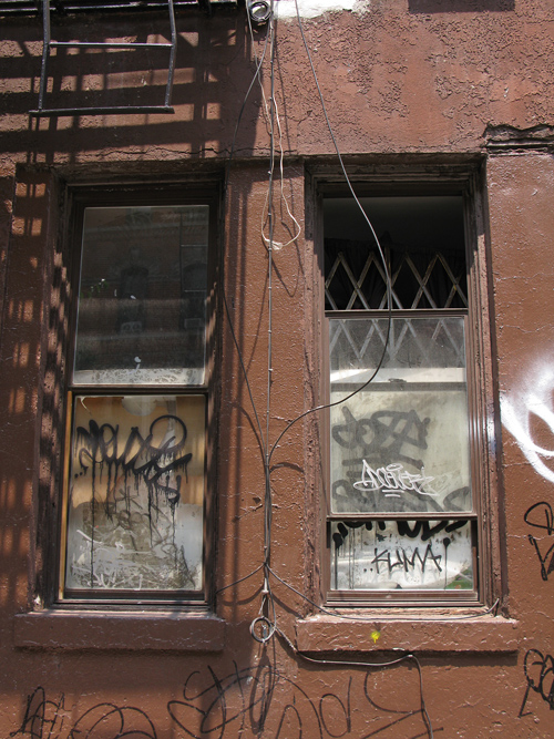 graffiti on a building and two windows, Manhattan, NYC