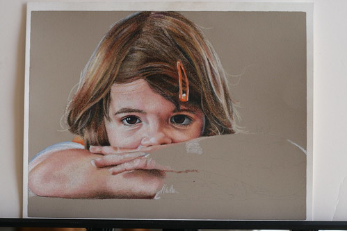 In progress photo of an as yet untitled colored pencil portrait of my daughter.