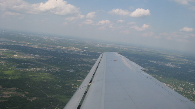 Photograph of the horizon taken from a wing seat of an airplane.