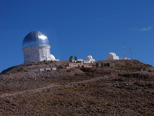 The towers for the four meter and one and a half meter telescopes, along with other smaller ones, are at the highest point in the neighborhood.