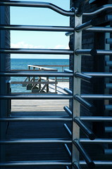 a view of the sea from behind the turnstile