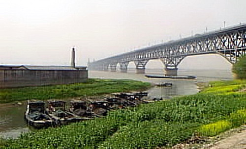 Nanjing Yangtze River Bridge. Busy river traffic and Nanjing#39;s great Yangtze River Bridge in spring 2000. It carries double railway tracks and an upper level roadway.