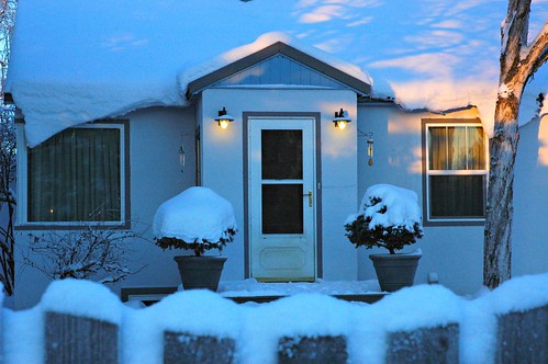 Christmas Eve, blue: house, trees, fence, snow, lights, windows, door, sunlight,  Anchorage, Alaska, USA by Wonderlane