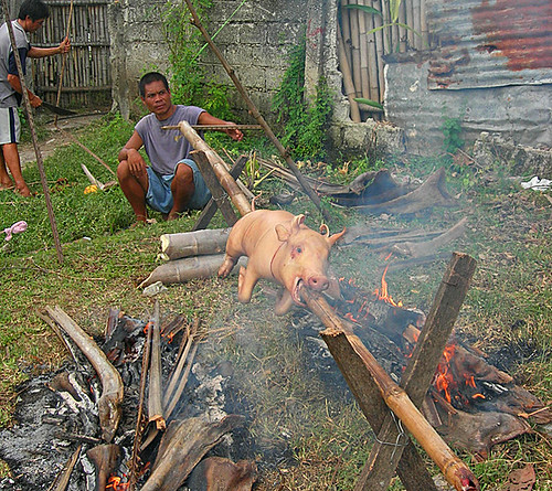 Philippines,Pinoy,Filipino,Pilipino,Buhay,Life,people,pictures,photos,city,rural,scene, man, traditional, sitting cooking pig roasting lechon