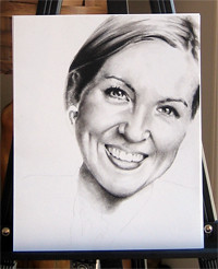 In progress photo of carbon pencil drawing entitled Ashley