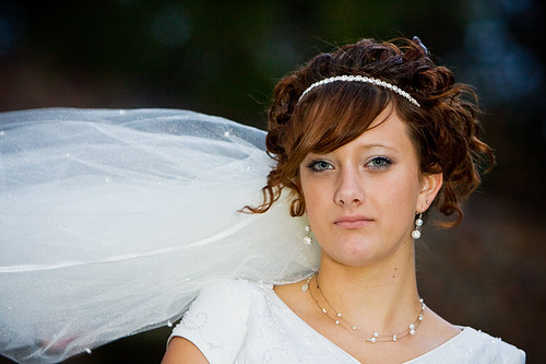 Bride with headband veil curly updo hairstyle 