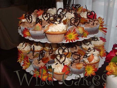 This photo is a closeup of a tall tier of wedding cupcakes for a fall 