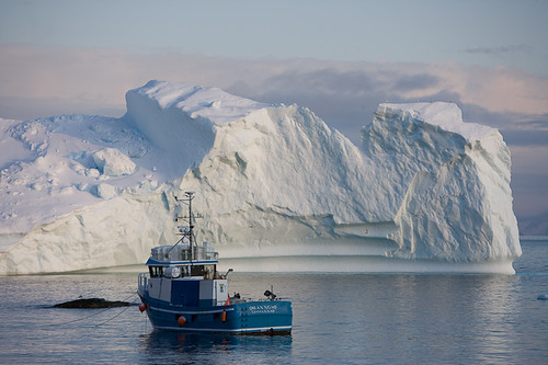 Fishing boat beside melting glaciers