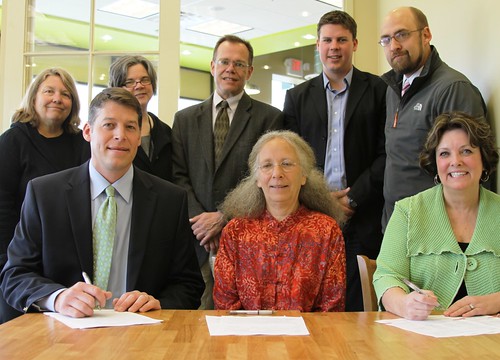 Colleen Landkamer, Minnesota State Director (Seated, Right) joins banking and community officials in signing funding documents for the St. Peter Food Co-op. 