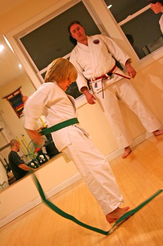 Putting on his green belt
