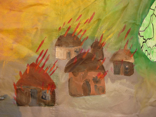 Burning village painting at encampment for Darfur