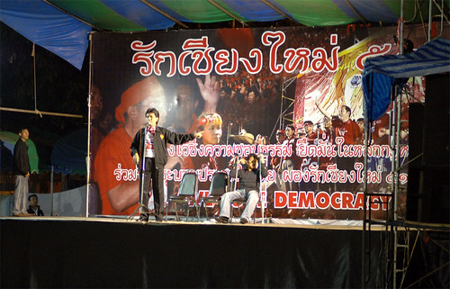 Speakers try to warm up the crowds on a very cold Chiang Mai evening