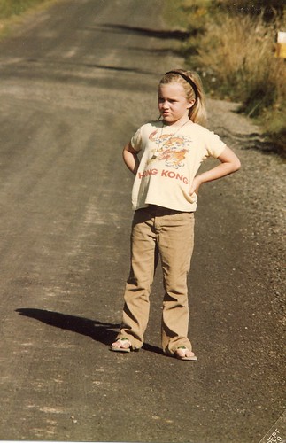 around age 6, already with scowl and hands on hips