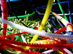 Painted snake in a pipe cleaner cage