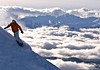 A snowboarder above the clouds and on the slopes of Whistler Blackcomb, B.C.