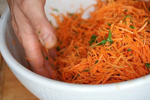 stirring carrot salad