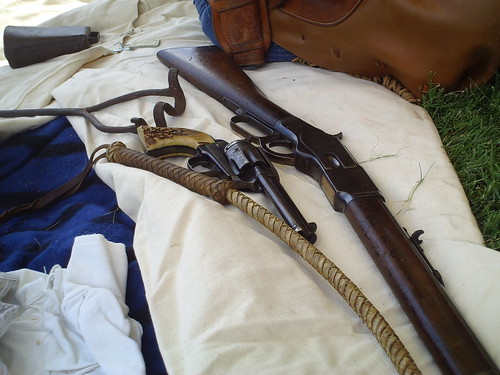 A whip, a Colt revolver, and a rifle