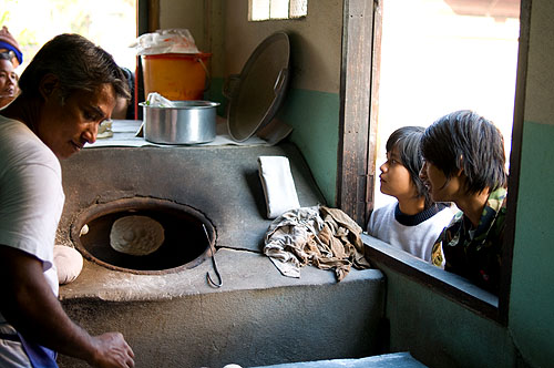 Baking bread in a tandoor oven at a Muslim restaurant in Mae Sot