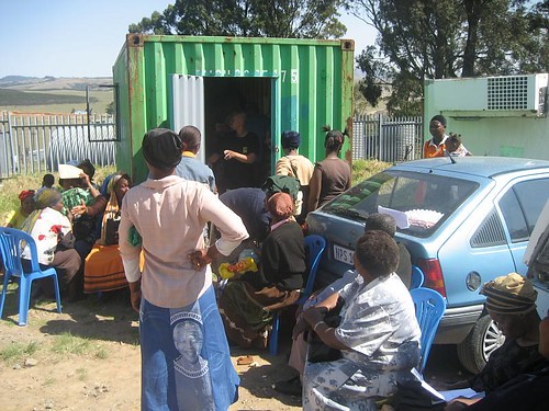 Village health workers waiting to get their nutrition parcels outside the Hlomelikusasa container.