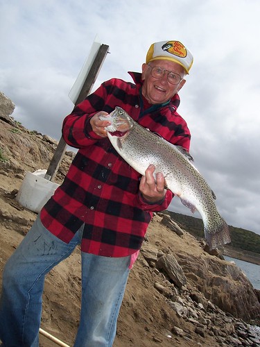 Fisherman shows off his catch at Diamond Lake near Hemet, California