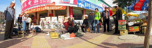 Street-side shoe repair in Huini, Gansu Province, China