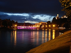 Photo of Inverness at night, with the Ness Bridge and castle lit up
