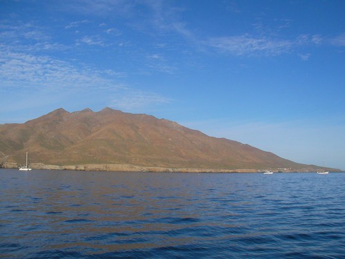 Boats in the anchorage of Bahia Santa Maria, mountain in background