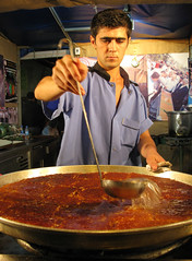 Pouring syrup on fresh Peynirli Künefesi, Ramazan street fair, Istanbul, Turkey
