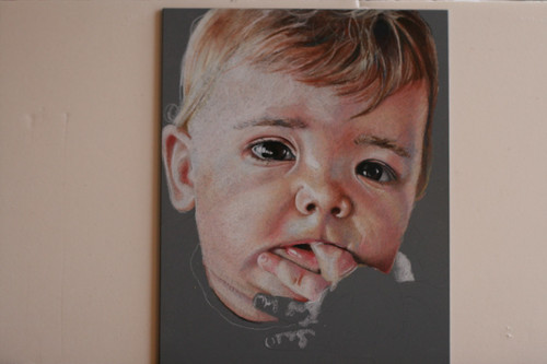 In progress photo of colored pencil portrait entitled Emre at 7 Months.