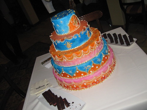 A gorgeous bohemian themed wedding cake from Masque Ristorante flanked by 