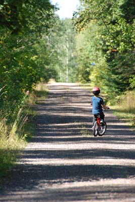 logan bikes down the lake road