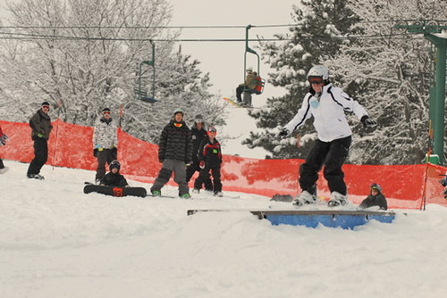  perform a trick on a rail in the terrain park at Afton Alps, Minnesota