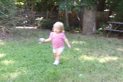 running with her ball across the yard