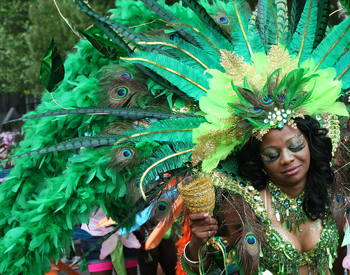 Woman dancer with big false eyelashes and green and peacock