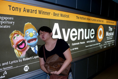 Singapore Nov 2008 - Suanie posing in front of an AvenueQ poster